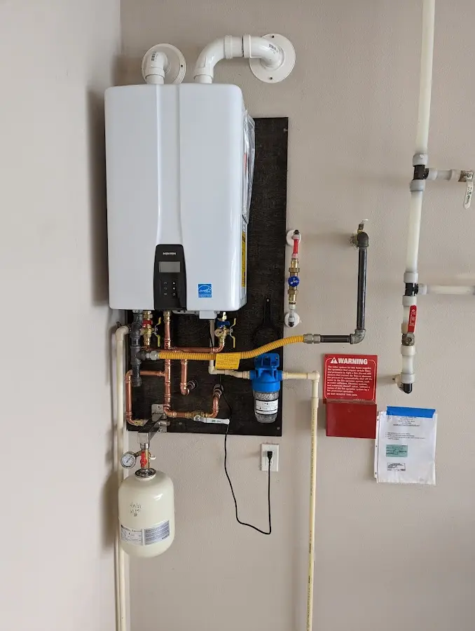 Professional plumber installing copper piping in a Homer home